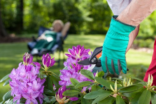 Professional landscapers working on a patio installation in Acton
